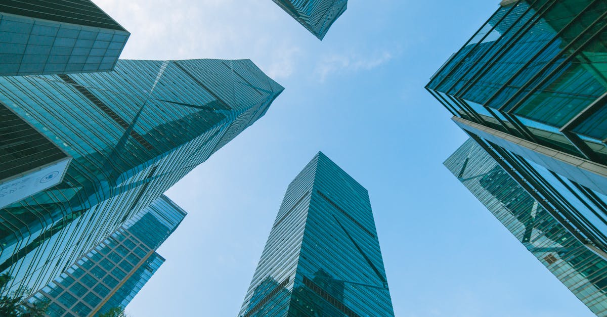 Low angle view of contemporary skyscrapers in Shenzhen, China under a clear blue sky.